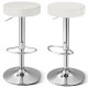 Close-up of the white PU leather seat of a swivel barstool with chrome footrest, showcasing its stylish design and.