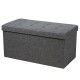 Foldable dark gray storage ottoman with padded seat, sturdy MDF frame, and roomy interior for blankets and clothes.