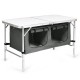 Height adjustable gray folding camping table with storage lockers, designed for easy transport and stability.