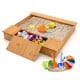 Kids wooden sandbox with bench seats and storage boxes, made of cedar wood, perfect for outdoor play with friends.