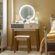 Makeup dressing table with lighted round mirror, 4 drawers, and solid beech wood legs for elegant bedroom decor.