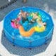 Family enjoying the 12 ft outdoor swimming pool with metal frame, featuring durable PVC fabric and easy drainage.