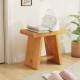 Teak shower bench with curved seat, showcasing solid construction and smooth edges, perfect for indoor or outdoor use.