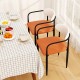 Modern dining chairs set of 2 with padded orange seats and curved backs, perfect for stylish dining experiences.