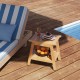 Teak wood shower bench with storage shelf, slatted design, and adjustable foot pads, perfect for versatile use.
