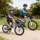 Two kids riding a 20-inch navy bike with adjustable features, kickstand, and storage basket in a park setting.