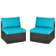 Two armless patio chairs with blue cushions, made of hand-woven rattan, perfect for outdoor relaxation.