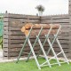 Heavy duty portable foldable steel sawhorse supporting logs, featuring a triangular structure for stability and easy.