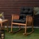 Tufted black outdoor patio chair cushion with string ties, offering comfort for indoor and outdoor relaxation.