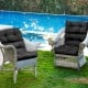 Tufted black outdoor patio chair cushion with string ties for non-slip use, ideal for indoor and outdoor relaxation.