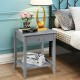 Gray wooden bedside table featuring a spacious tabletop, pull-out drawer, and open shelf for convenient storage.