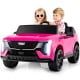 Two kids enjoying a pink 24V licensed Cadillac ride-on truck with remote control, featuring safety belts and.
