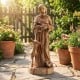 St. Francis statue with bird feeder, rustic brown finish, 24.5 inches tall, ideal for garden decoration and attracting.