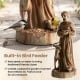 St. Francis statue with built-in bird feeder, rustic brown finish, perfect for gardens and attracting birds.