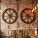 Decorative 24-inch wooden wagon wheels in carbonized fir wood, enhancing rustic charm on walls or barn doors.