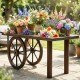 Decorative wooden wagon wheel table made of carbonized fir wood, perfect for enhancing rustic indoor and outdoor spaces.