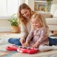 Kids playing with a red dinosaur-shaped 25-key piano keyboard, promoting music interest and creativity in a cozy.