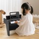 25-key black kids piano keyboard with adjustable speed and volume, perfect for toddlers aged 3+, promoting musical.