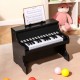 25-key black kids piano keyboard with sheet music holder, ideal musical toy for toddlers aged 3+, promotes coordination.