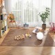 Brown wood grain foam floor mats arranged in a cozy play area with toys and plants, perfect for children's spaces.