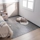 Gray wood grain foam floor mats with borders arranged in a cozy bedroom setting, enhancing comfort and style.