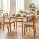 Square bamboo dining table for 2-4 people with natural finish, set in a cozy living space, ideal for small areas.
