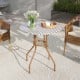 27.5-inch outdoor bistro table with a durable metal frame and adjustable foot pads, perfect for patio or garden use.
