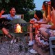 28-inch portable fire pit on wheels with log grate, ideal for heating or barbecue, shown in a social outdoor setting.