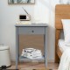 Gray wooden bedside table with a compact design, pull-out drawer, and open shelf, perfect for optimizing small spaces.