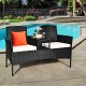 Wicker patio conversation set with removable cushions, featuring a tempered glass table, ideal for poolside relaxation.