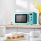 Retro green 0.9 cu.ft countertop microwave oven with a clear viewing window, ideal for small apartments and offices.