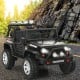 Kids electric ride-on truck in black with remote control, spring suspension, and realistic lights for outdoor fun.
