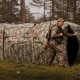 Hunting blind with camouflage pattern, featuring one-way see-through panels and modular design for 2-6 persons.