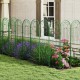 Green metal garden trellis set with floral design, 71 x 20 inches, providing sturdy support for climbing plants.