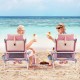 Two people enjoy drinks while seated in pink 5-position outdoor folding beach chairs with a side table for snacks.