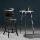 Black swivel counter stool with upholstered seat and rubber wood construction, perfect for dining areas or bars.