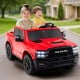 Red 2-seater licensed Ram truck ride-on toy for kids, featuring remote control, music, and safety belts for fun outdoor.