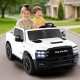 Two kids enjoying a ride in a white 2-seater licensed Ram truck toy with remote control and LED lights.