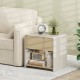 Modern 2-tier nightstand in oak with a drawer and open shelf, perfect for organizing essentials beside a sofa.