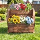 2-tier rustic wood wagon-shaped garden bed with vibrant flowers, featuring drainage holes and wheels for easy mobility.