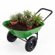 Heavy-duty light green wheelbarrow with plants, featuring a steel frame and 330 lbs capacity for gardening tasks.