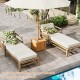 Square acacia wood side table with slatted design and storage, ideal for outdoor use by the pool or patio.