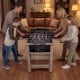 Family enjoying the 2-in-1 swivel game table, featuring a brown finish and sturdy H-shaped legs for balanced gameplay.