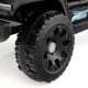 Close-up of a rugged black tire from the 12V kids ride-on truck, featuring a textured design for smooth driving.
