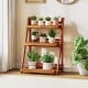 Foldable 3-tier solid wood plant stand with smooth shelves, ideal for potted plants and home decor in any setting.