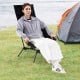 High back portable camping chair in black, featuring a built-in pillow and compact carry bag, perfect for outdoor.