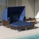 Outdoor daybed with retractable navy canopy, cushioned PE wicker rattan for patio relaxation and sun protection.