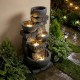 Five-tier outdoor water fountain with LED lights, gray stone finish, creating a calming ambiance for patios.