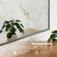 Brushed metal wall-mounted cabinet featuring an arched mirror and adjustable shelves for stylish and functional storage.