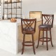 360° swivel counter height chairs with PU leather cushioned seats and rubber wood construction for stylish kitchen.
